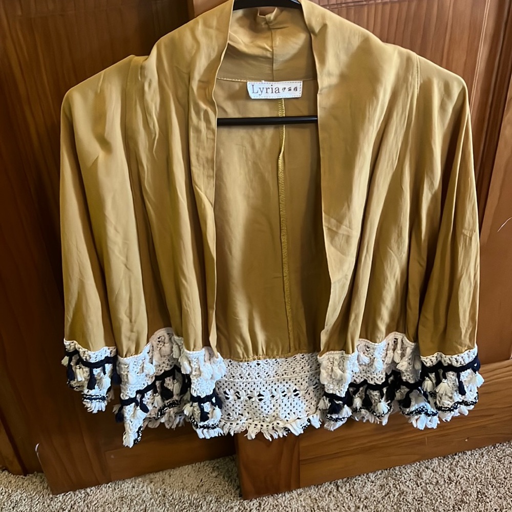 Gold cotton jacket with 3/4 length sleeve and interesting trim at bottom